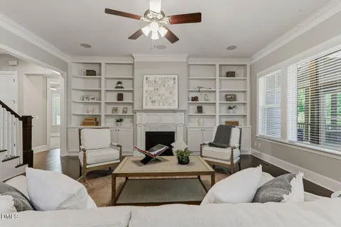 a kitchen with stainless steel appliances kitchen island granite countertop a stove a sink a refrigerator and a dining table with wooden floor