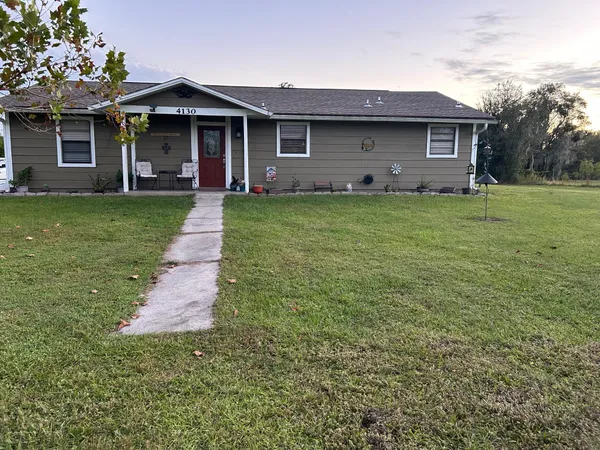a view of a lush green outdoor space with a lake view