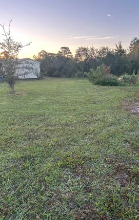 a view of backyard with seating area