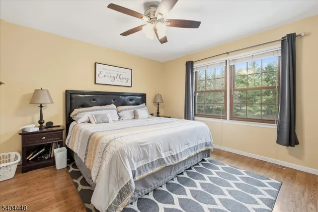 a bedroom with a bed and a flat tv screen on the dresser