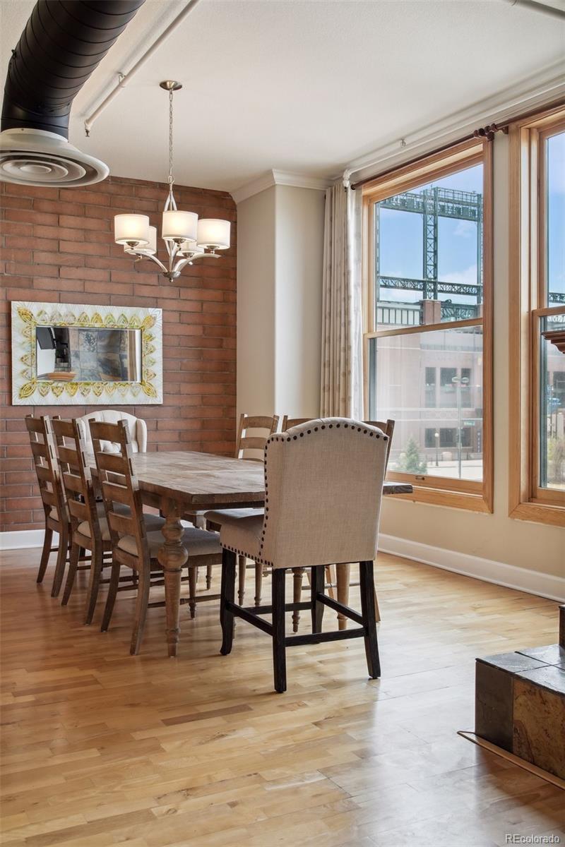 2245 Blake Street, Unit C Denver, CO 80205 - Photo 11 of 40 a view of a dining room with furniture window and wooden floor