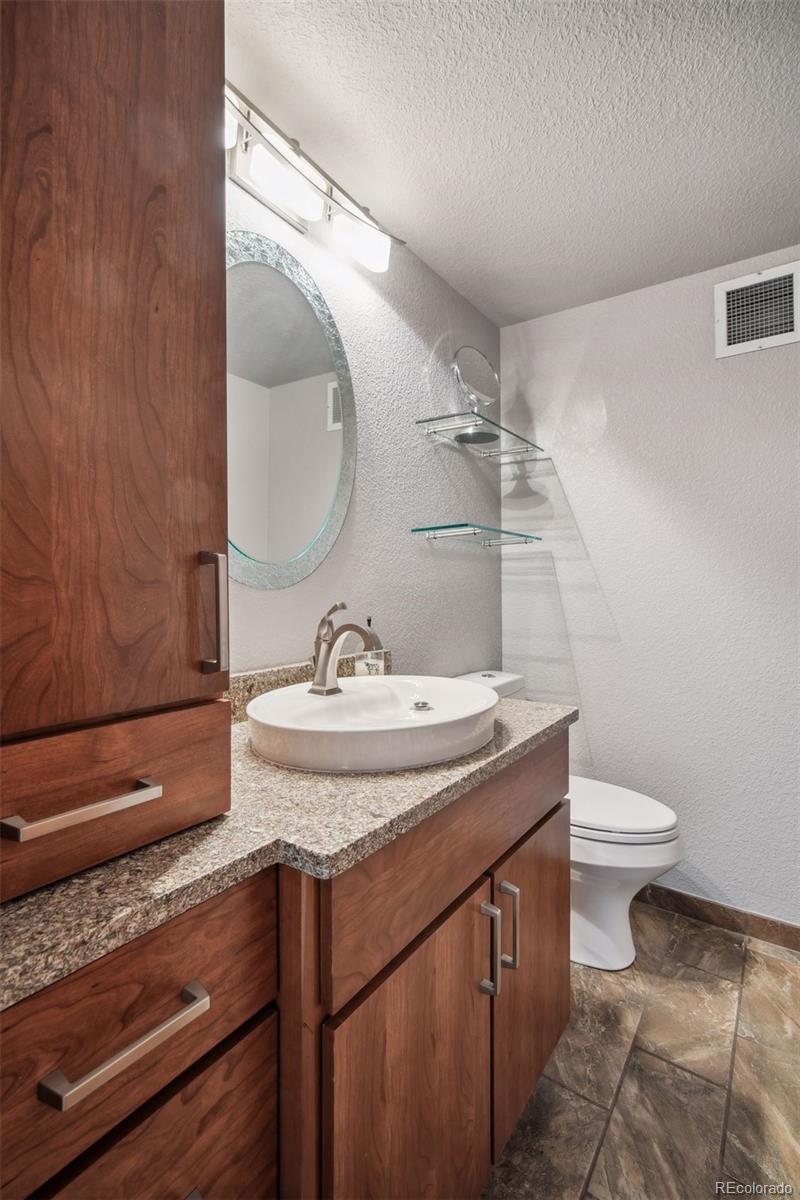 2245 Blake Street, Unit C Denver, CO 80205 - Photo 19 of 40 a bathroom with a sink and mirror with toilet