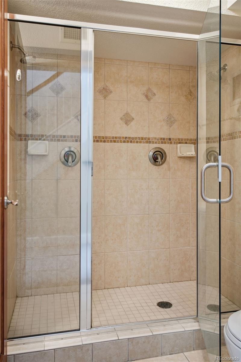2245 Blake Street, Unit C Denver, CO 80205 - Photo 23 of 40 a bathroom with a glass shower door