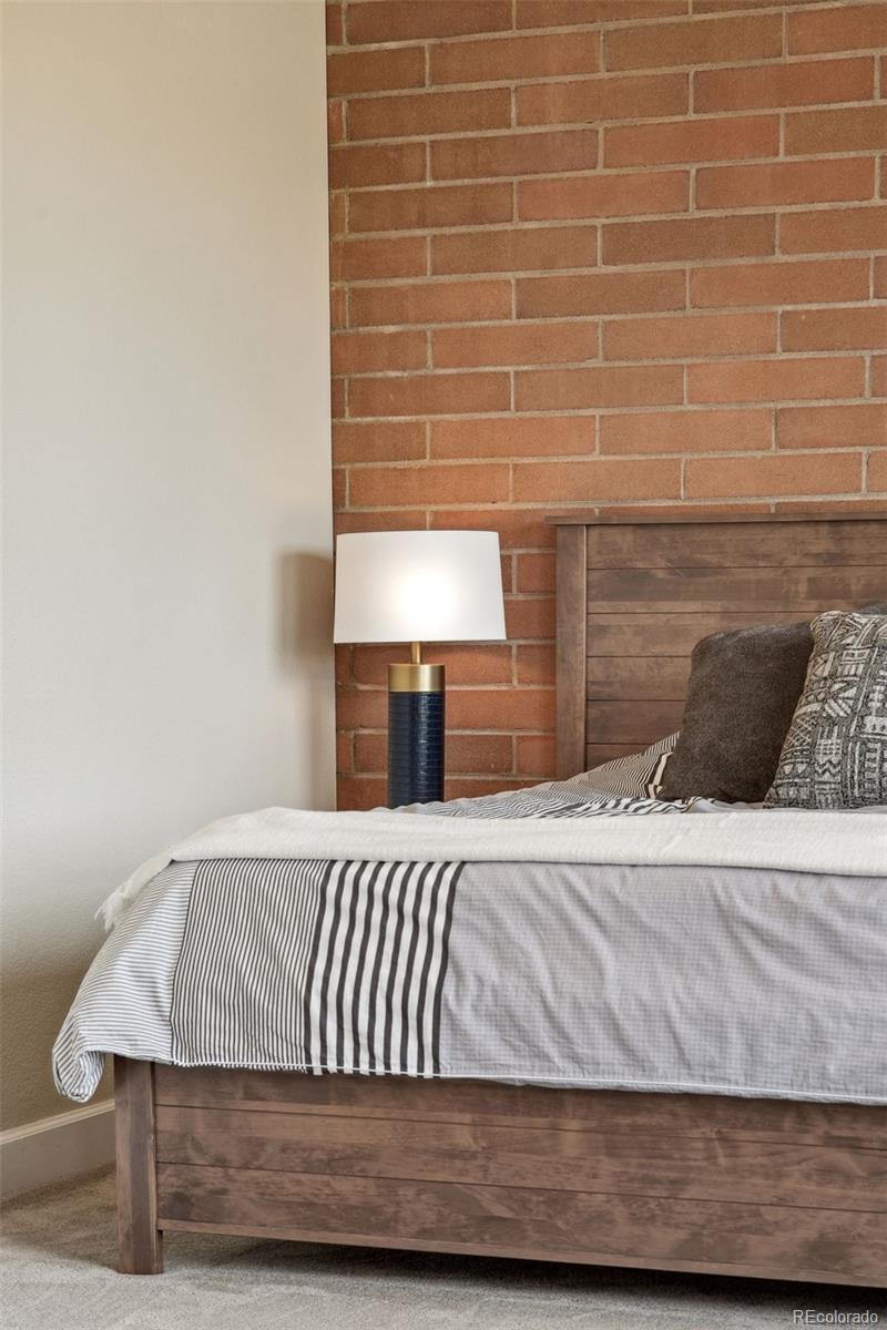 2245 Blake Street, Unit C Denver, CO 80205 - Photo 27 of 40 a bedroom with a bed and a lamp