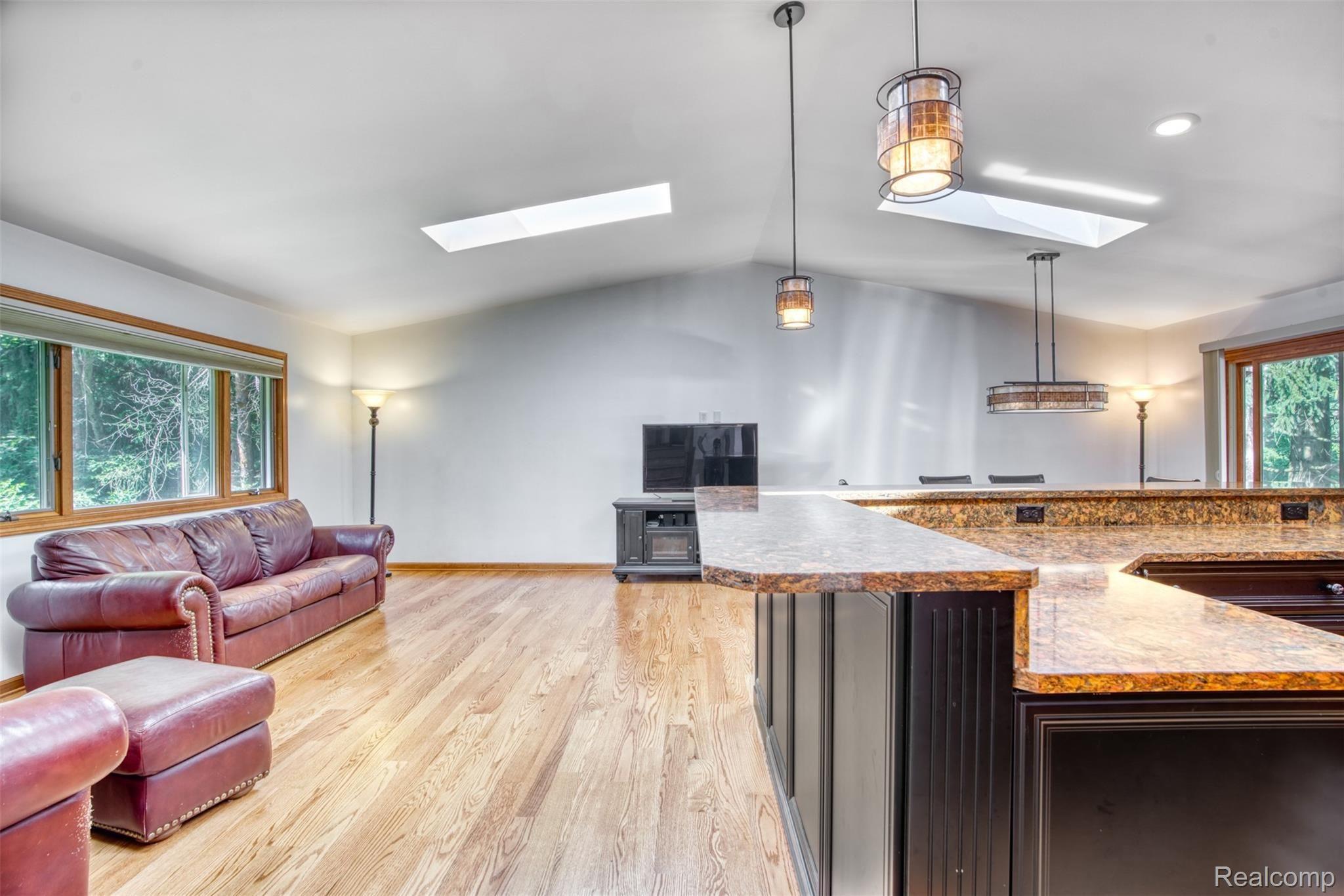 11813 Newman Road Brighton, MI 48114 - Photo 5 of 33 Living room open to kitchen, wooded views