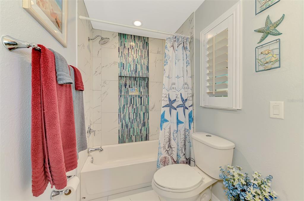 5868 Jefferson Road Venice, FL 34293 - Photo 42 of 68 Sparkling Jewel-like accent band in completely updated Bathroom