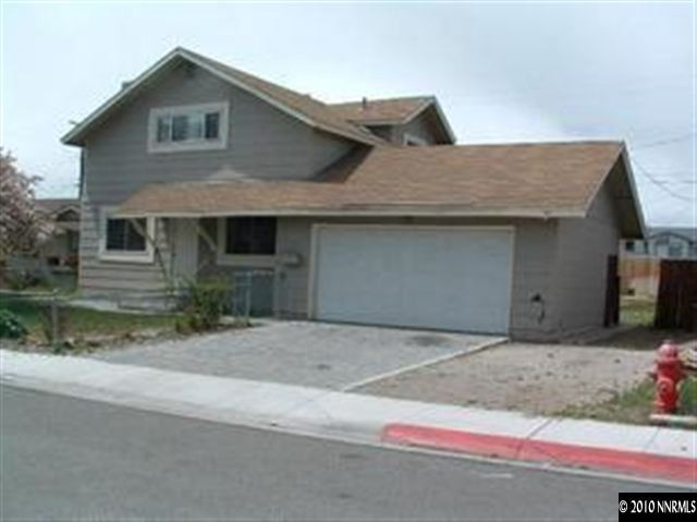 1075 Monitor Drive Reno, NV 89512 - Photo 1 of 6 a front view of a house with a yard and garage
