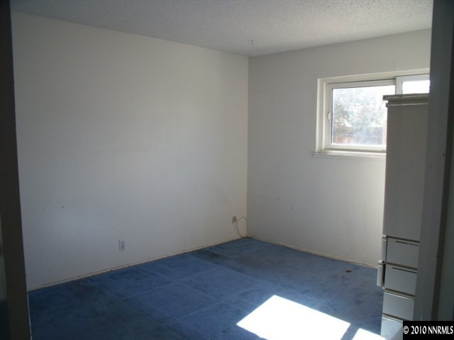 1075 Monitor Drive Reno, NV 89512 - Photo 5 of 6 an empty room with wooden floor and windows