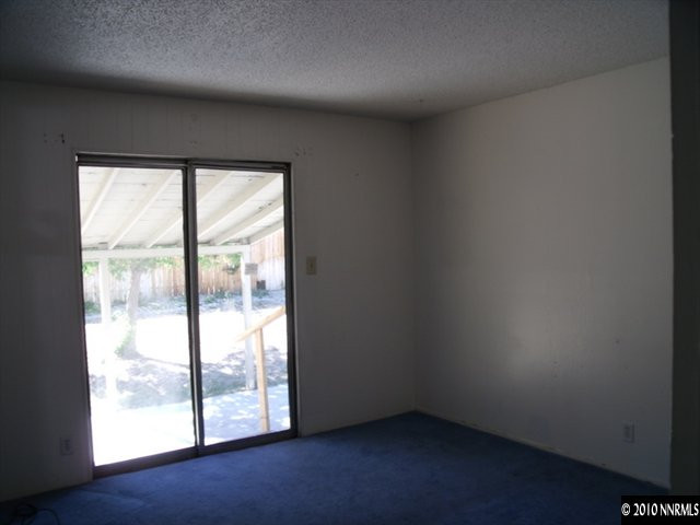 1075 Monitor Drive Reno, NV 89512 - Photo 6 of 6 an empty room with wooden floor and windows
