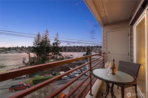 a city view from a balcony with furniture