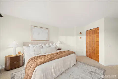 a bedroom with a bed and a lamp