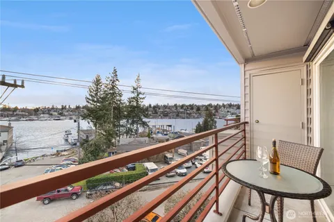 a city view from a balcony with furniture