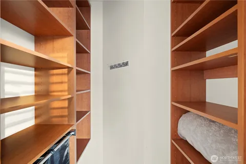 a view of walk in closet with empty racks