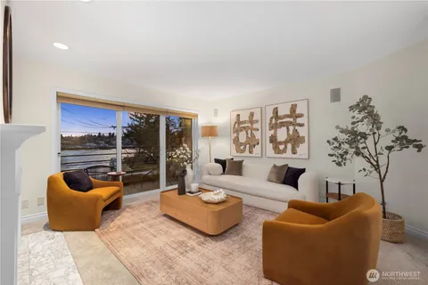 a living room with furniture and a potted plant