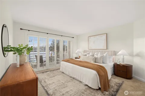 a bedroom with a balcony a bed and a couch