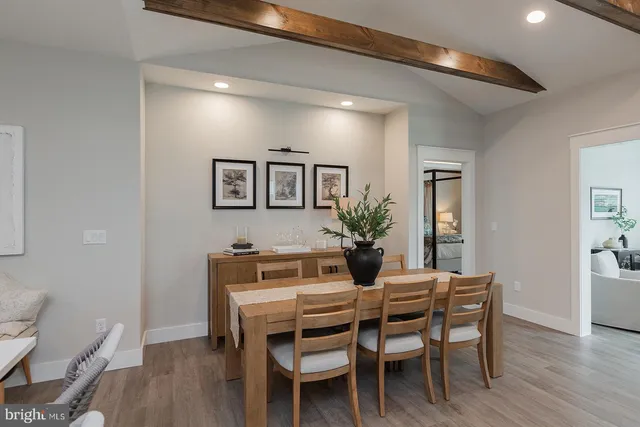 a dining room with furniture and wooden floor