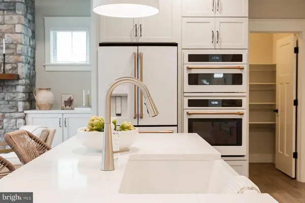 a kitchen with stainless steel appliances kitchen island granite countertop a stove a sink and a microwave