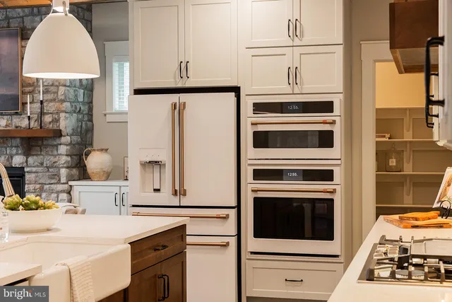 a kitchen with stainless steel appliances a stove and a refrigerator