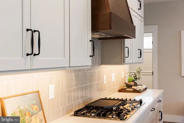 a kitchen with a stove and a window