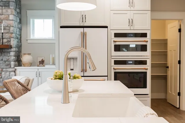 a kitchen with stainless steel appliances kitchen island granite countertop a stove a sink and a microwave