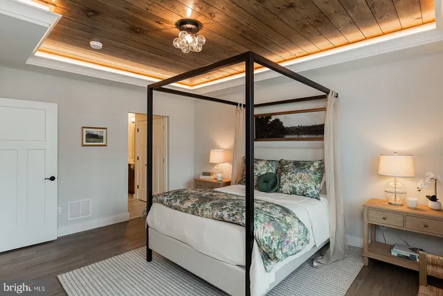 a bedroom with a bed and a mirror