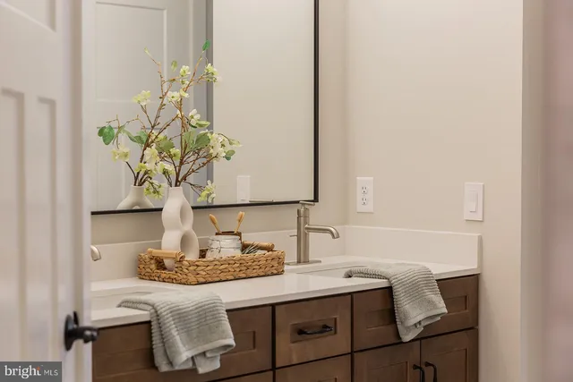 a bathroom with a granite countertop sink and a mirror