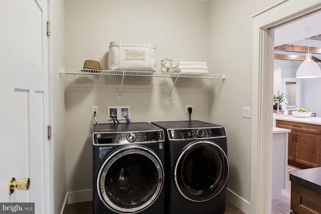 a utility room with sink dryer and washer