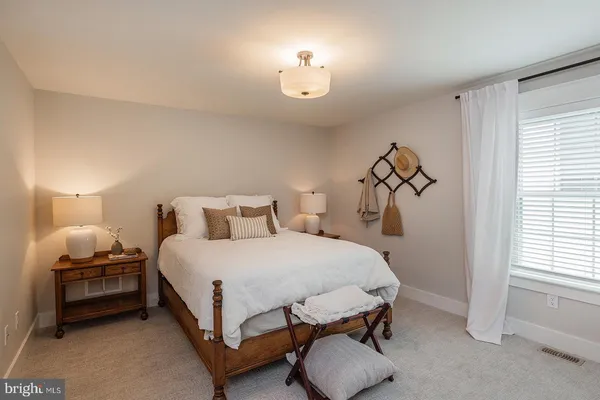 a bedroom with bed and a window
