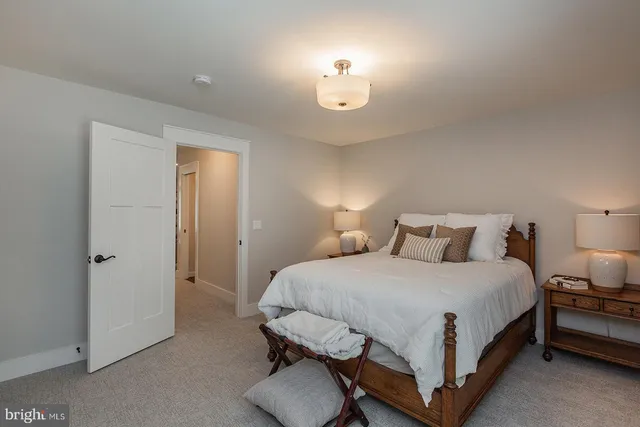a bedroom with bed and a chandelier