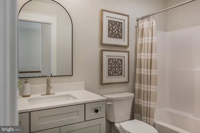 a bathroom with a toilet sink and shower
