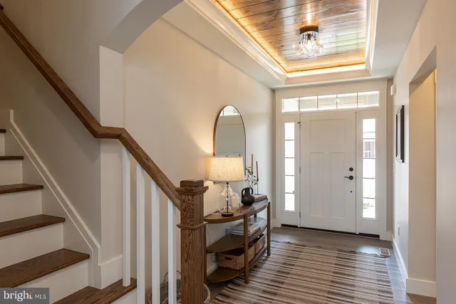a view of a livingroom with wooden floor and staircase