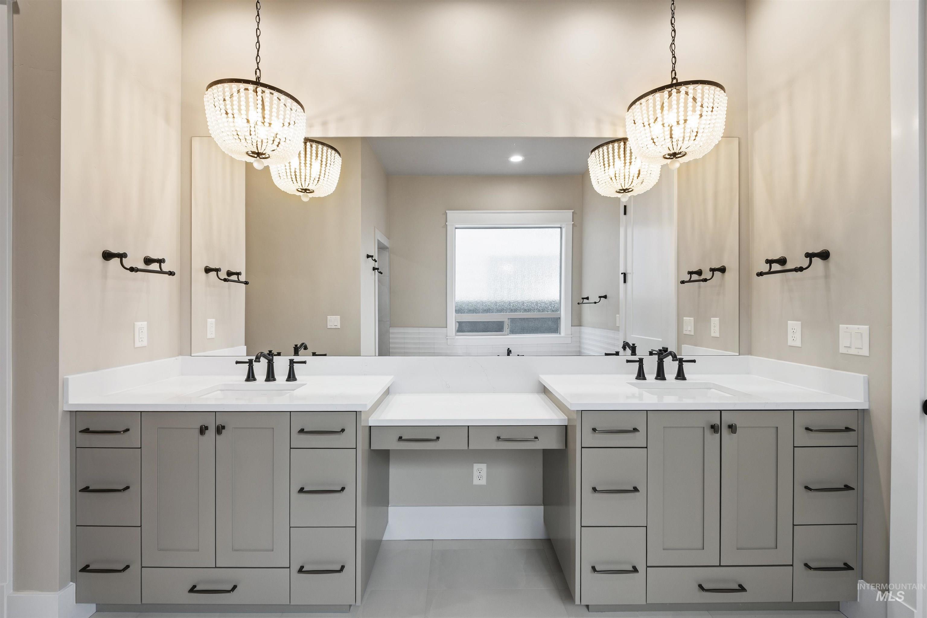 934 East Escalation Street Meridian, ID 83642 - Photo 12 of 50 Full bathroom with hanging lights, double vanity, and light tile patterned flooring