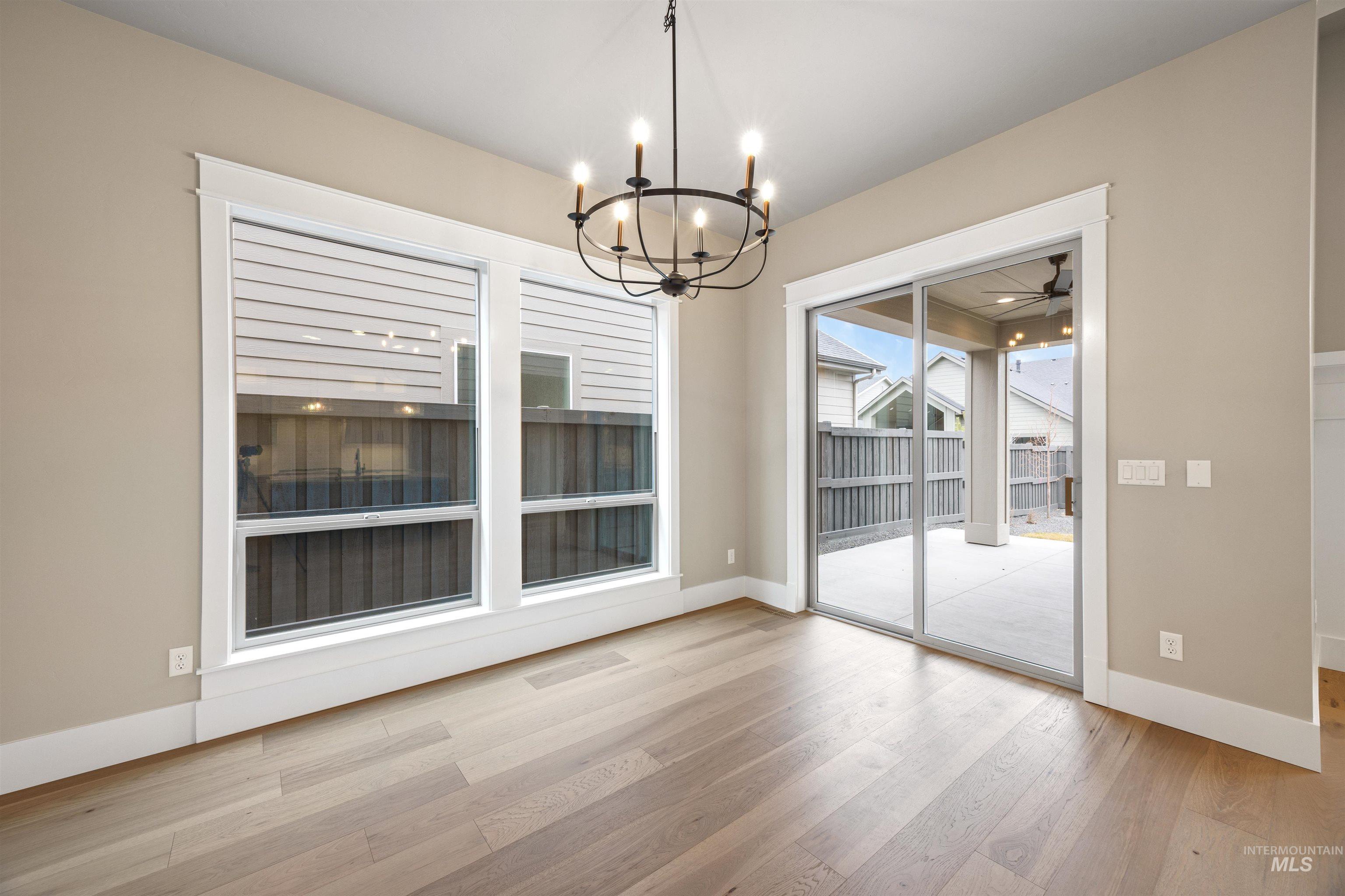 934 East Escalation Street Meridian, ID 83642 - Photo 21 of 50 Unfurnished dining area featuring hanging lights, light wood-type flooring, and ceiling fan