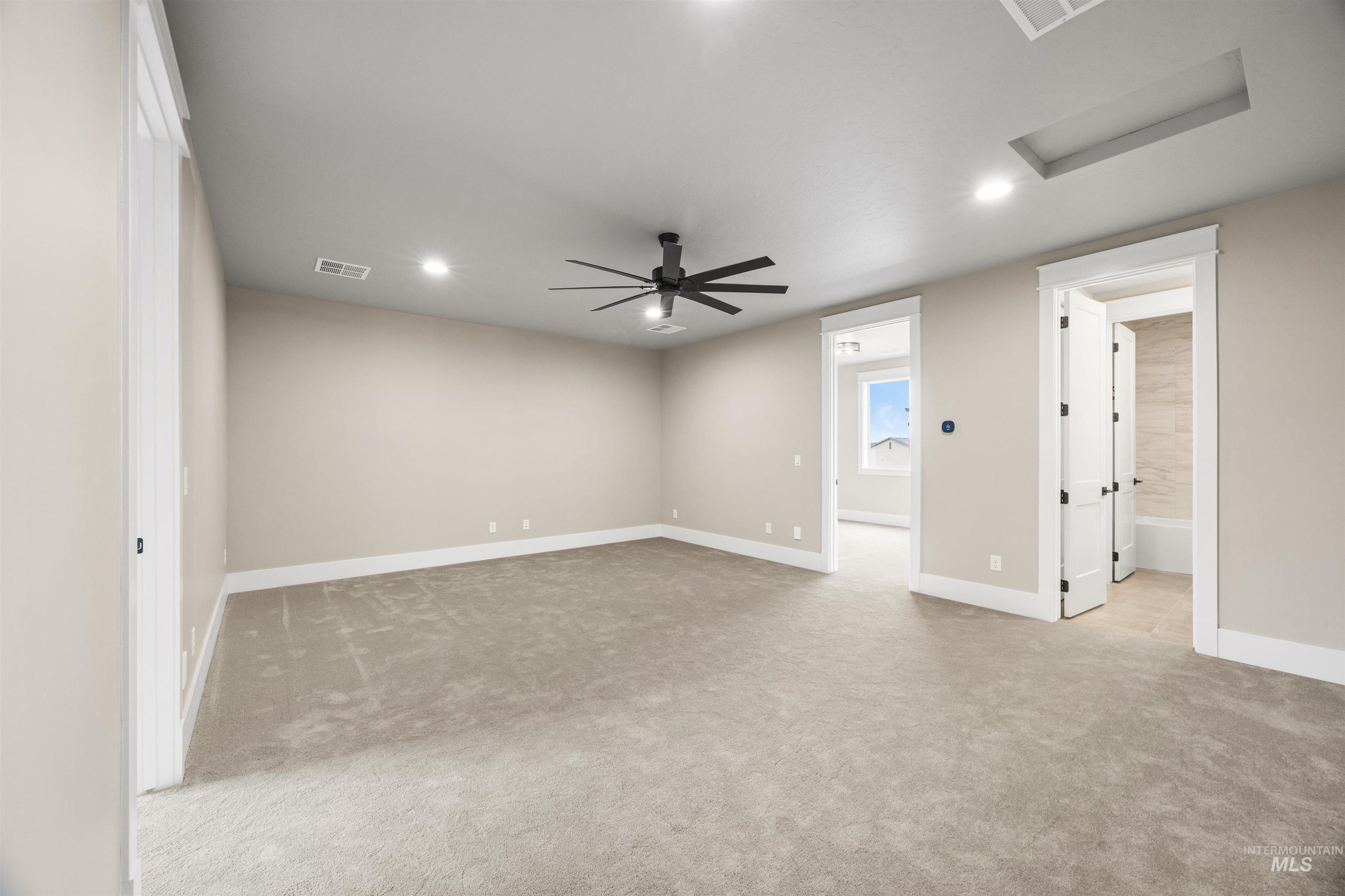 934 East Escalation Street Meridian, ID 83642 - Photo 36 of 50 Empty room with light colored carpet, ceiling fan, and recessed lighting