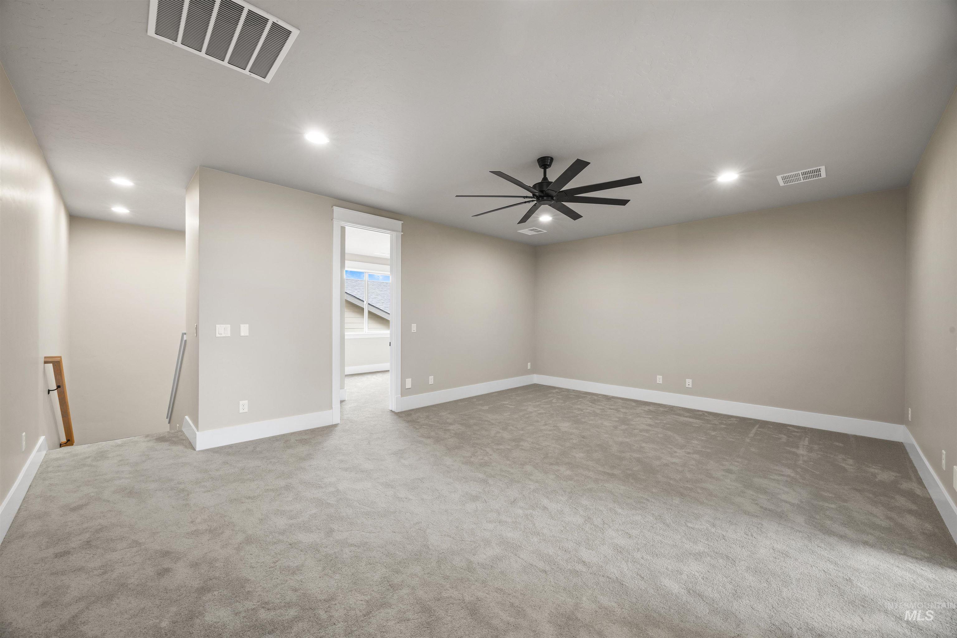 934 East Escalation Street Meridian, ID 83642 - Photo 39 of 50 Empty room with recessed lighting, light colored carpet, and a ceiling fan
