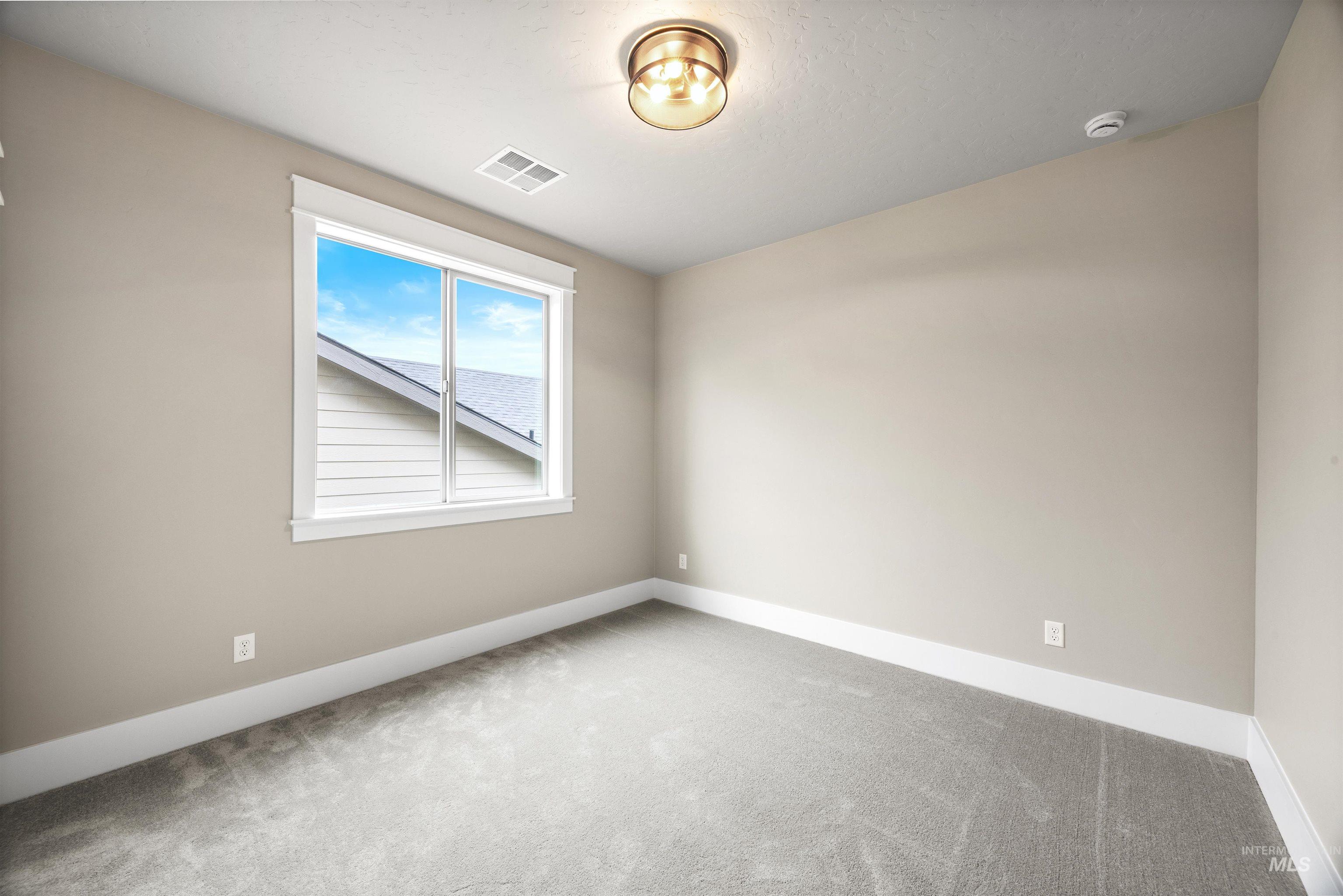 934 East Escalation Street Meridian, ID 83642 - Photo 40 of 50 Carpeted spare room featuring baseboards