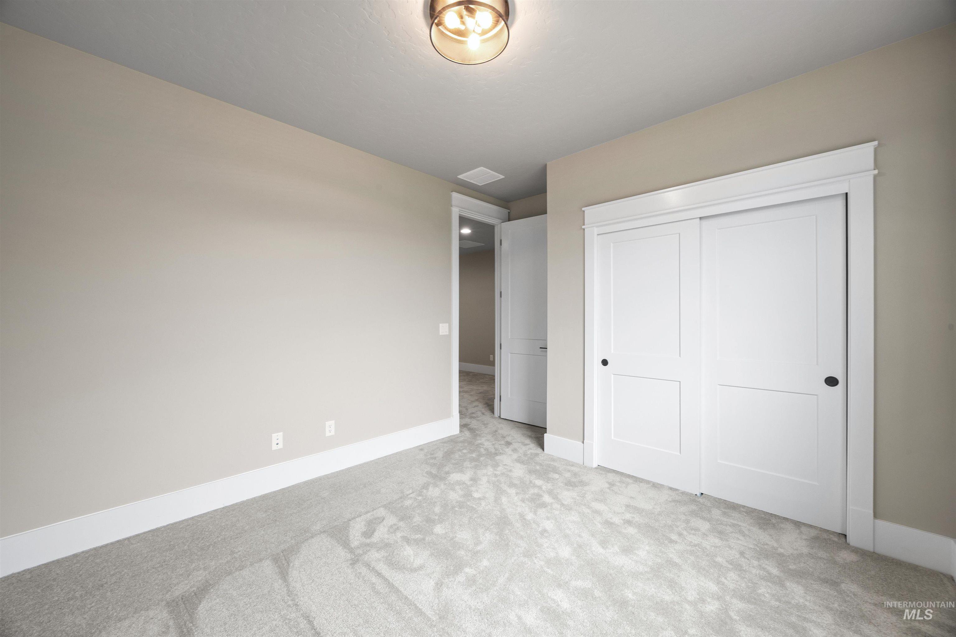934 East Escalation Street Meridian, ID 83642 - Photo 41 of 50 Unfurnished bedroom featuring a closet and carpet floors