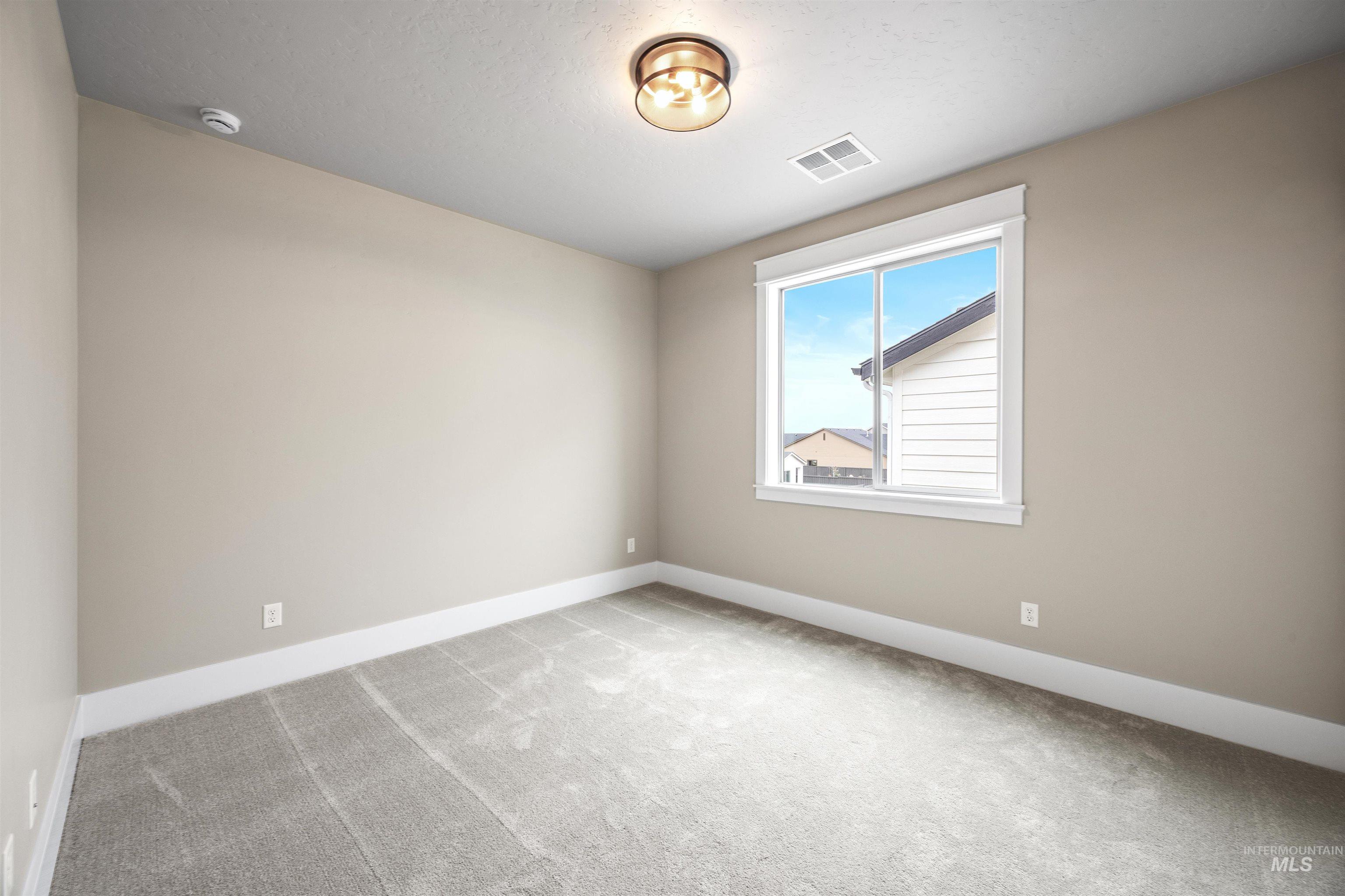 934 East Escalation Street Meridian, ID 83642 - Photo 42 of 50 Spare room featuring light colored carpet and baseboards