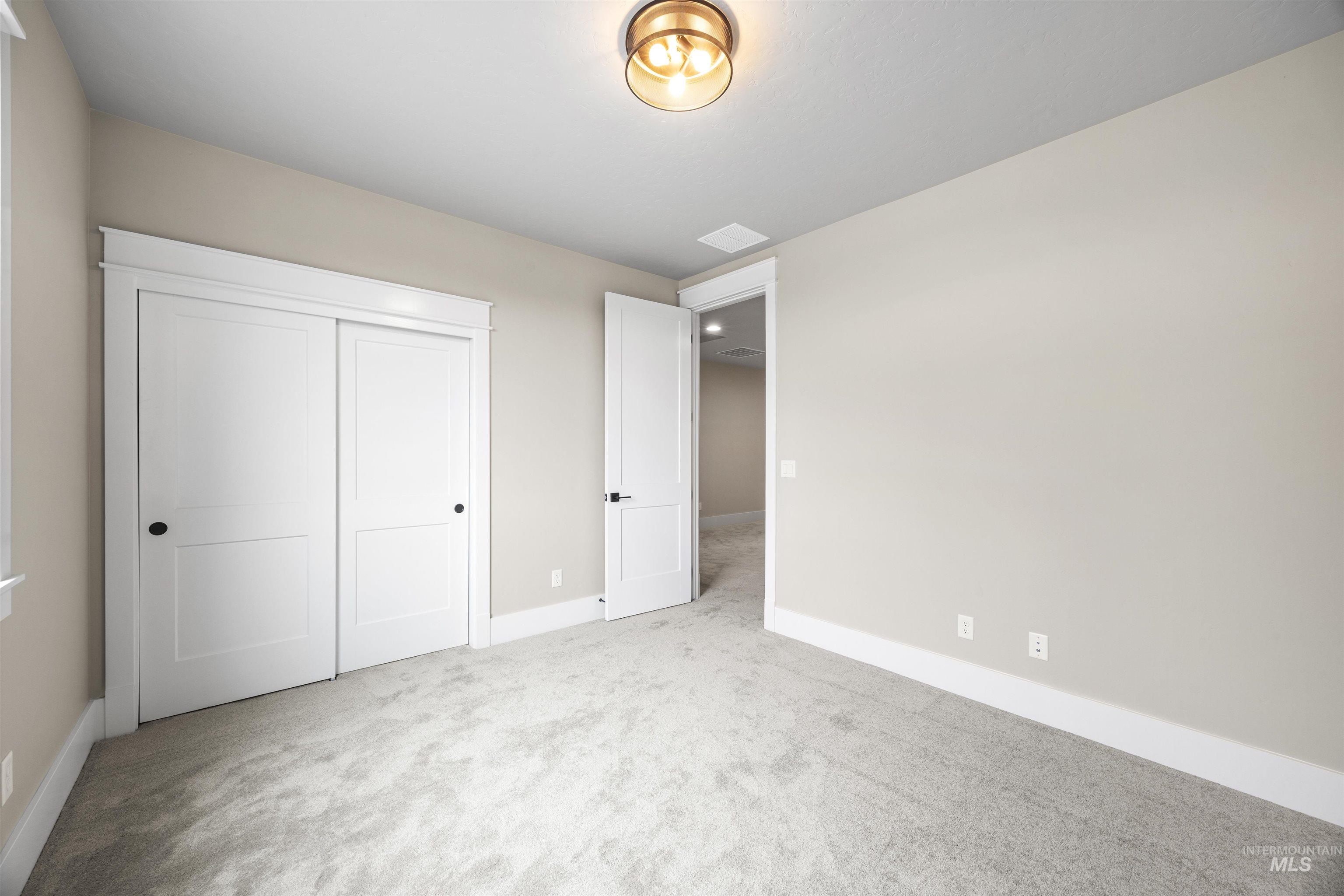 934 East Escalation Street Meridian, ID 83642 - Photo 43 of 50 Unfurnished bedroom featuring light colored carpet and a closet