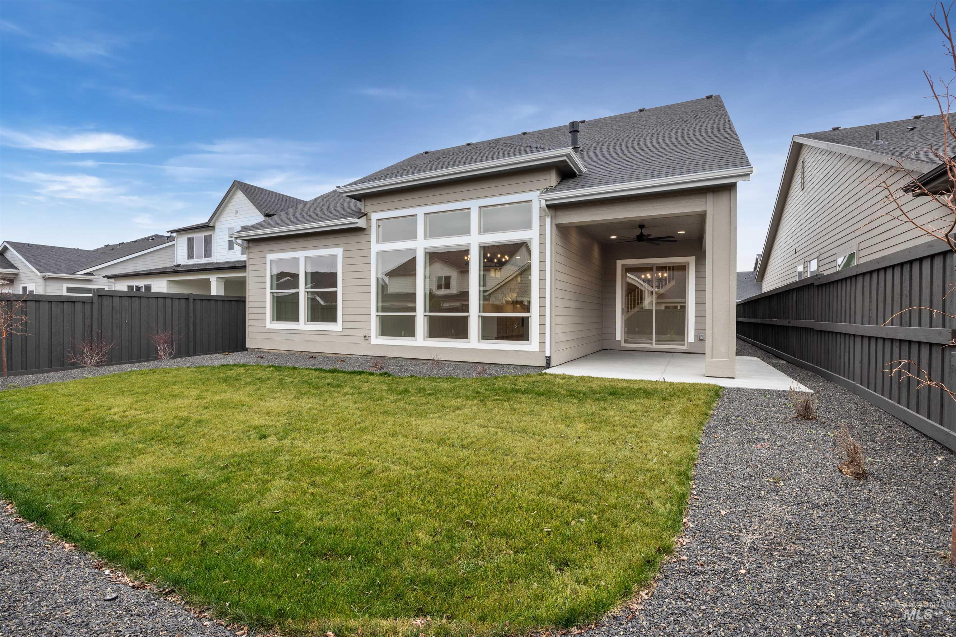 934 East Escalation Street Meridian, ID 83642 - Photo 45 of 50 Rear view of house with a patio area, a fenced backyard, a ceiling fan, and a shingled roof