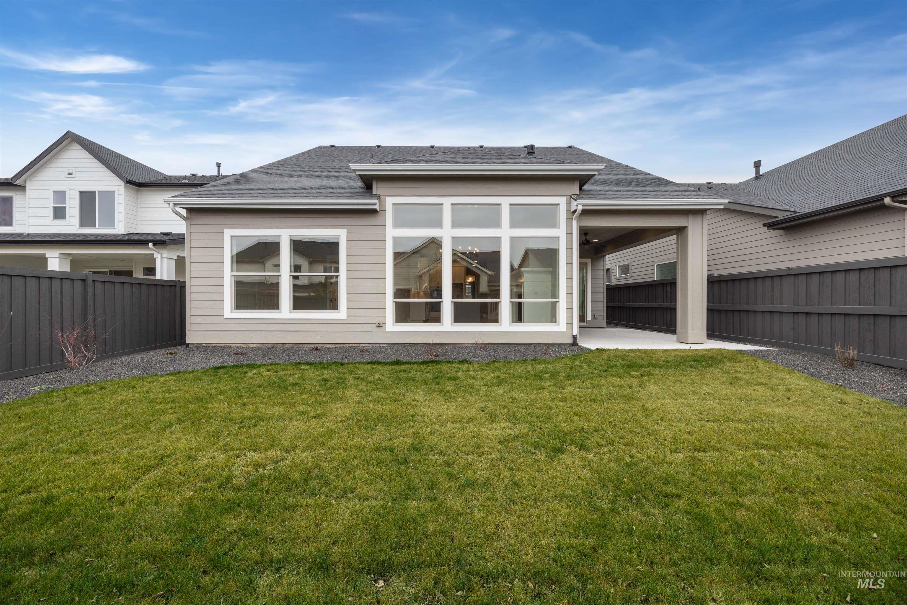 934 East Escalation Street Meridian, ID 83642 - Photo 46 of 50 Back of house with a patio area, a fenced backyard, and a shingled roof