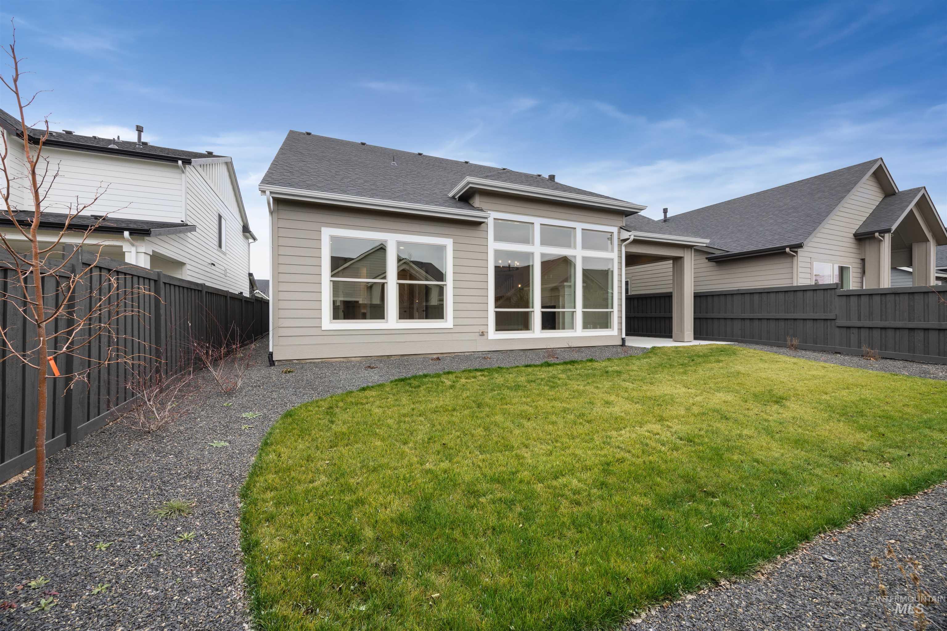 934 East Escalation Street Meridian, ID 83642 - Photo 47 of 50 Back of house featuring a fenced backyard and roof with shingles