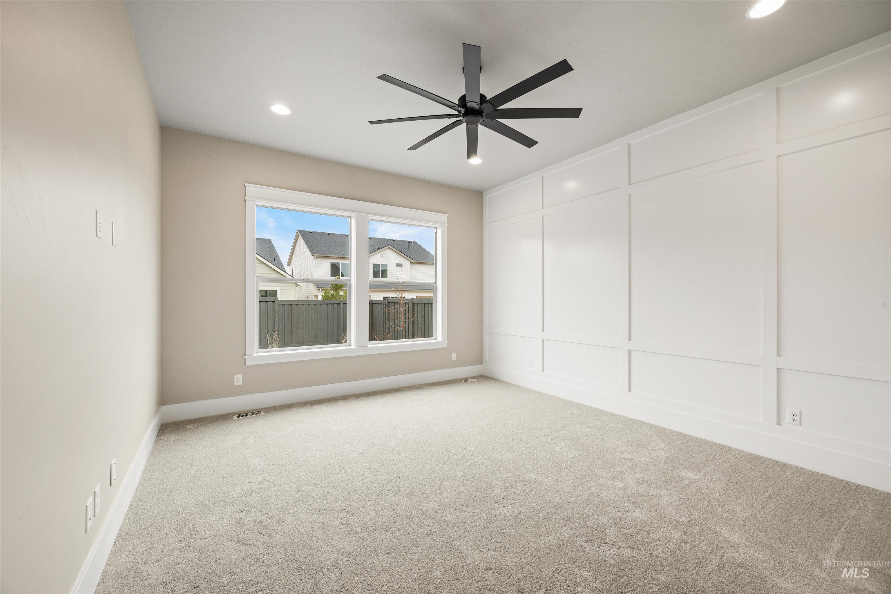 934 East Escalation Street Meridian, ID 83642 - Photo 9 of 50 Unfurnished room with a decorative wall, light colored carpet, and ceiling fan