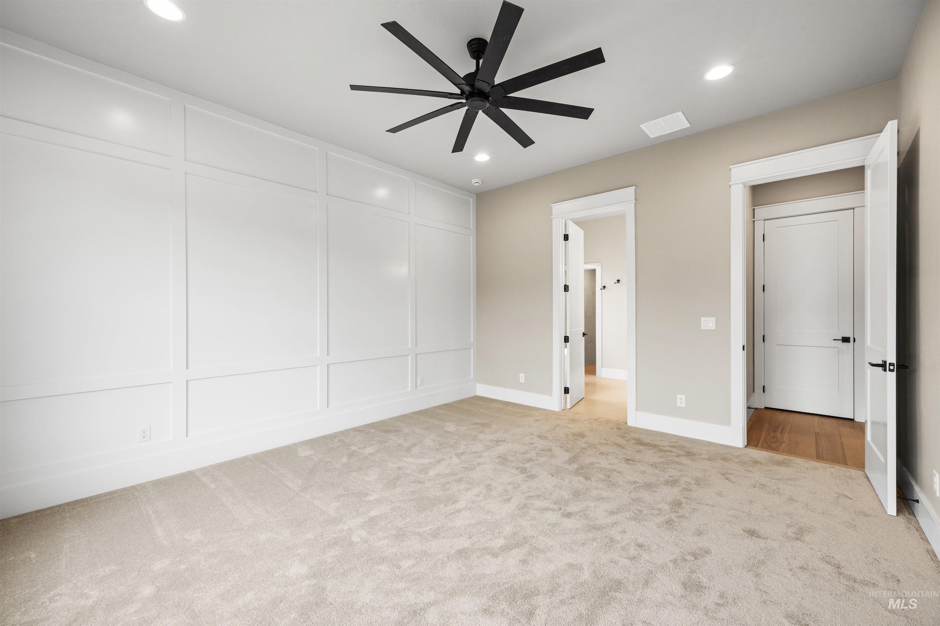 934 East Escalation Street Meridian, ID 83642 - Photo 10 of 50 Unfurnished bedroom featuring light carpet, recessed lighting, ceiling fan, and a decorative wall