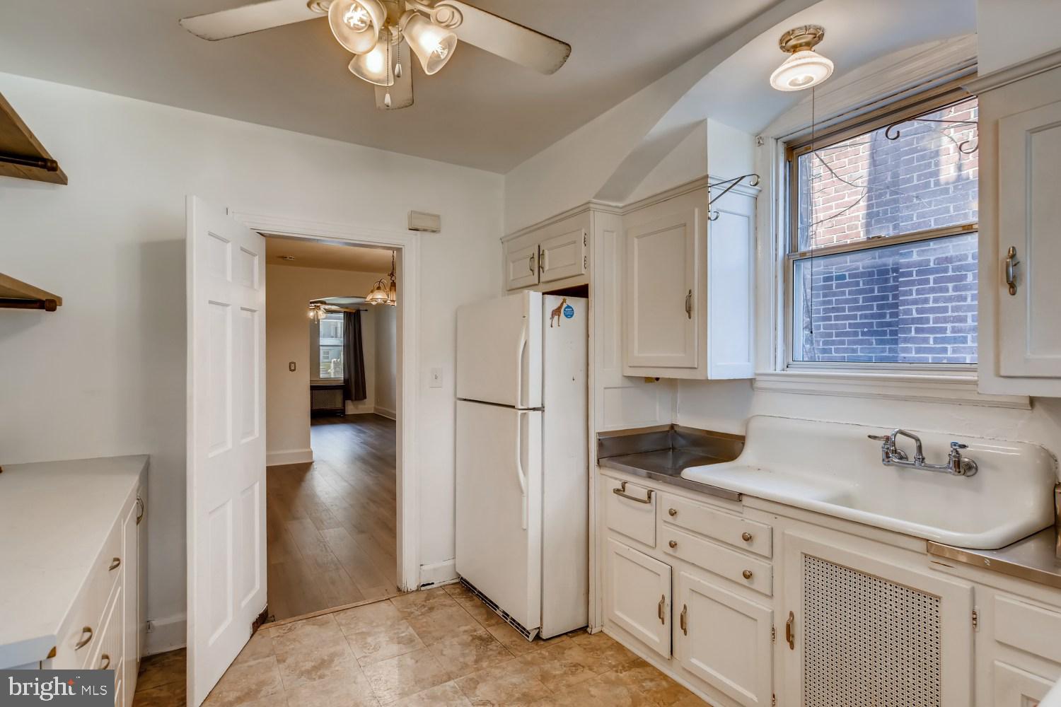 7103 Harford Road Baltimore, MD 21234 - Photo 11 of 27 a kitchen with cabinets appliances and a window