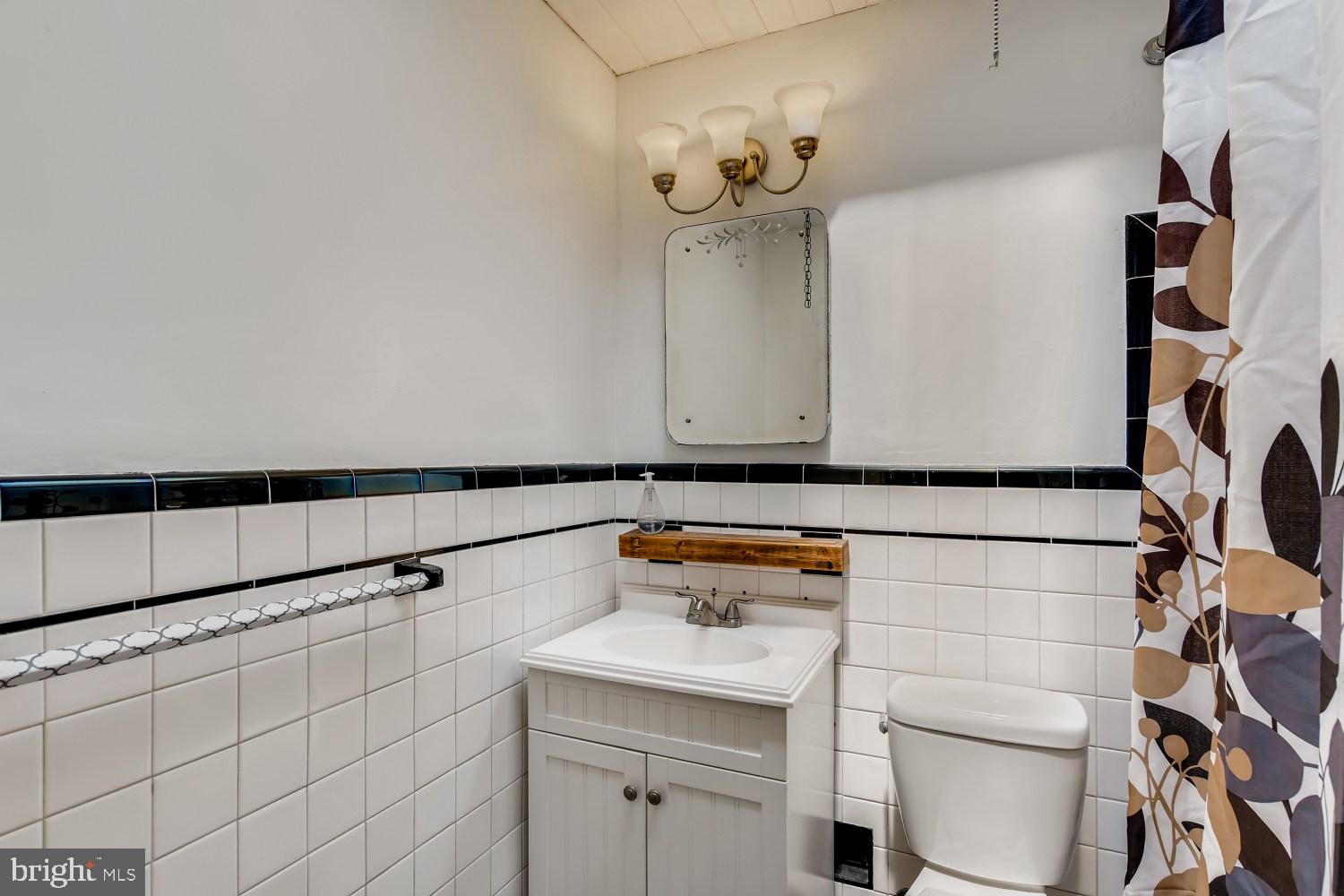 7103 Harford Road Baltimore, MD 21234 - Photo 15 of 27 a bathroom with a sink and a toilet