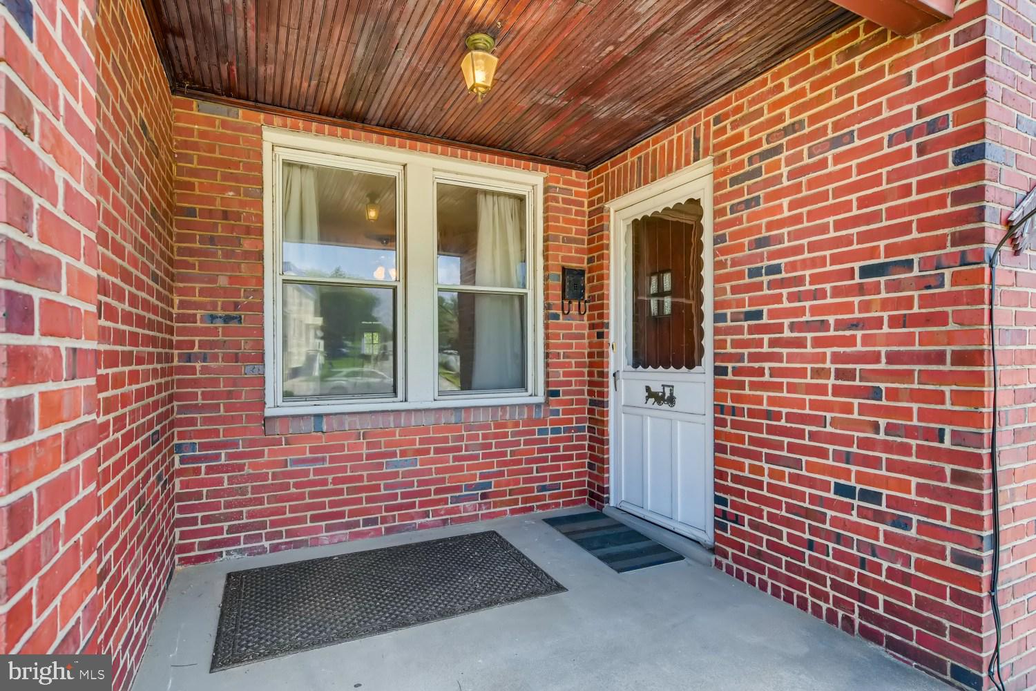 7103 Harford Road Baltimore, MD 21234 - Photo 3 of 27 a view of a brick house with a door and wooden floor