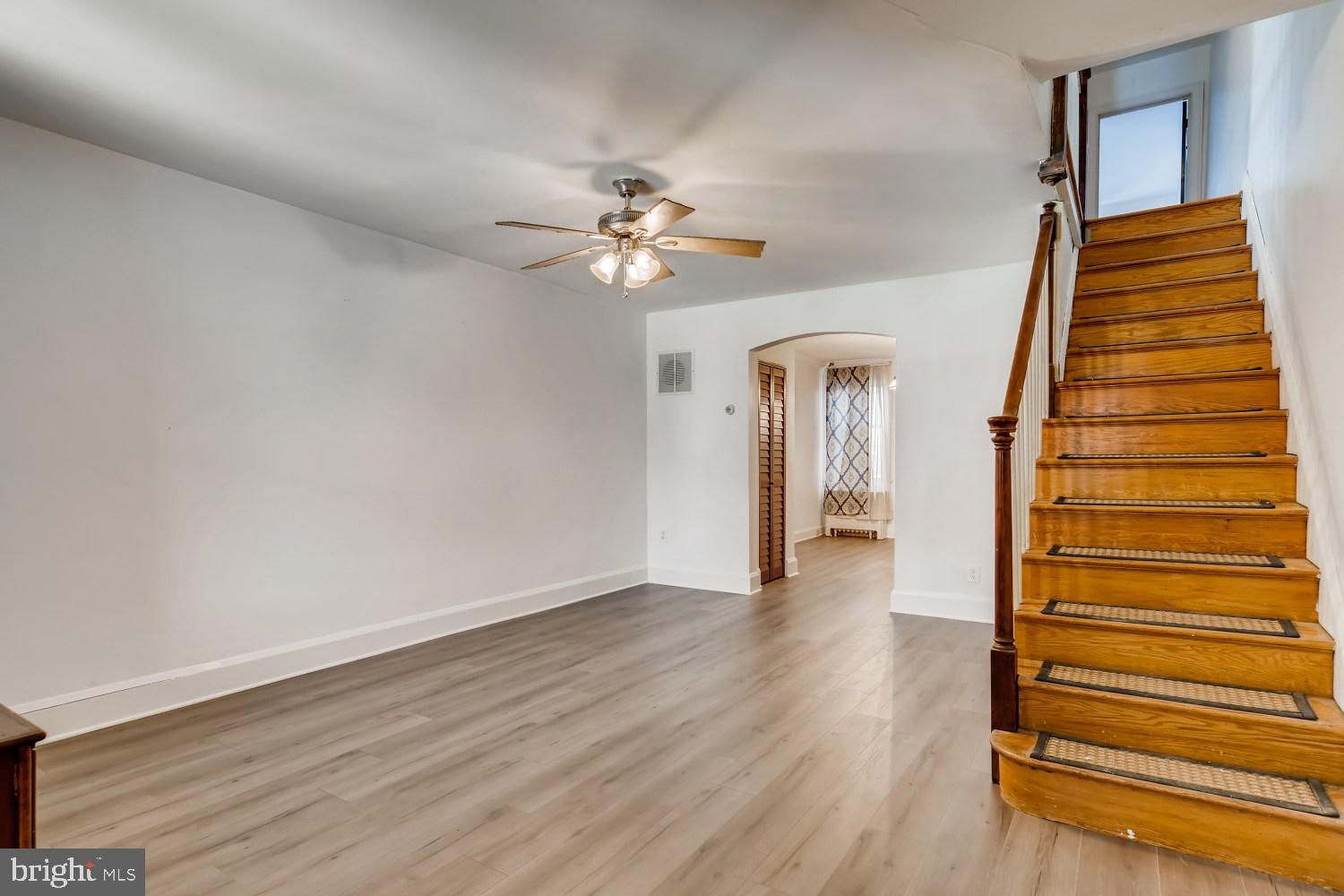 7103 Harford Road Baltimore, MD 21234 - Photo 5 of 27 wooden floor in an empty room with a window