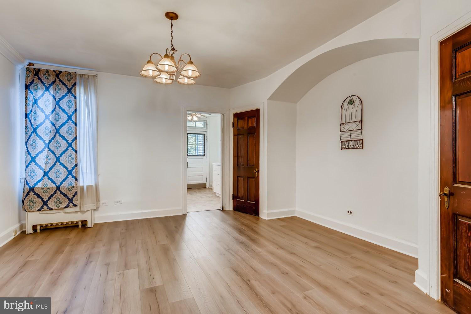 7103 Harford Road Baltimore, MD 21234 - Photo 7 of 27 wooden floor in an empty room with a window