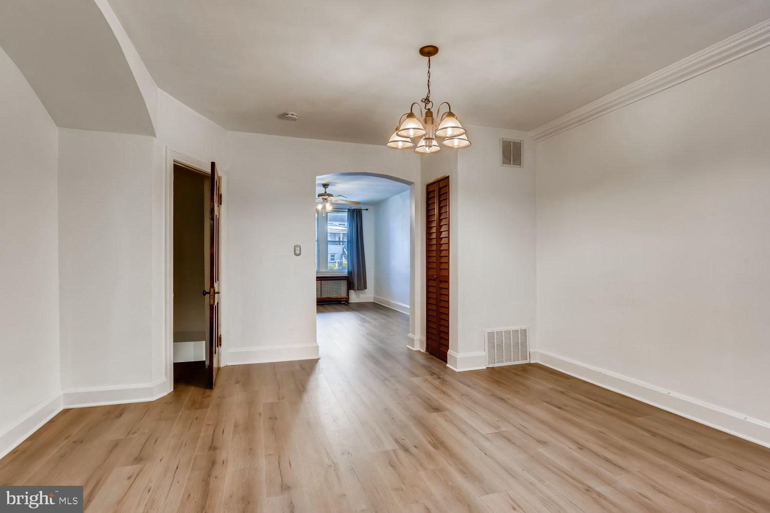 7103 Harford Road Baltimore, MD 21234 - Photo 8 of 27 a view of a room with wooden floor and chandelier